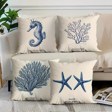 Load image into Gallery viewer, Decorative pillows with sea-themed designs on a sofa.