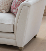 Load image into Gallery viewer, Beige sofa with patterned cushions on a wooden floor