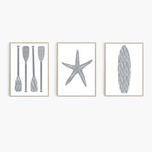 Load image into Gallery viewer, Three framed prints of a paddle, starfish, and abstract shape on a white wall.