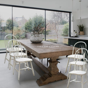 LARGE SALVAGED BLEACHED PINE DINING TABLE WITH SIX ANTIQUED WHITE TRADITIONAL CHAIRS