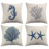 Four decorative pillows with blue sea-themed illustrations on a white background