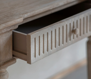 Wooden console table with a drawer on a light background