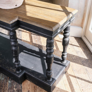 Stunning bleached oak topped console table. The detailing on this console makes it a firm favourite with the One World team. Not only does the unusual shape make it striking but add to that the distressed black finish and the textures wooden top and you have a real conversation piece. Just add lamps, a couple of beautiful mirrors and you are done.