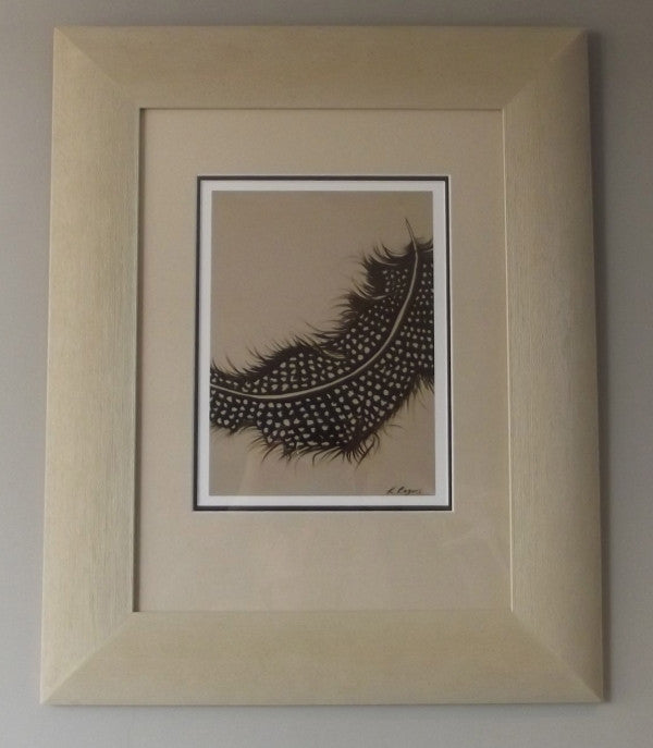 A Gineau Fowl feather Print in a Cream Frame 